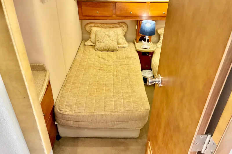 Slide: The Image of Cozy cabin interior of 2006 Rinker 390 Express Cruiser with bed and lamp. - 41