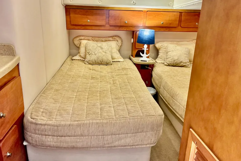 Slide: The Image of Interior cabin of 2006 Rinker 390 Express Cruiser with twin beds and cozy lighting. - 42