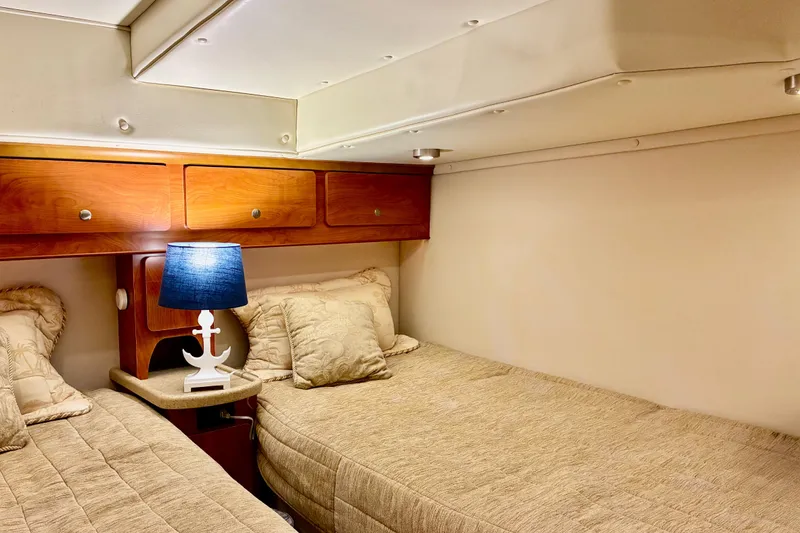Slide: The Image of Cozy cabin interior of 2006 Rinker 390 Express Cruiser with twin beds and nautical lamp. - 43