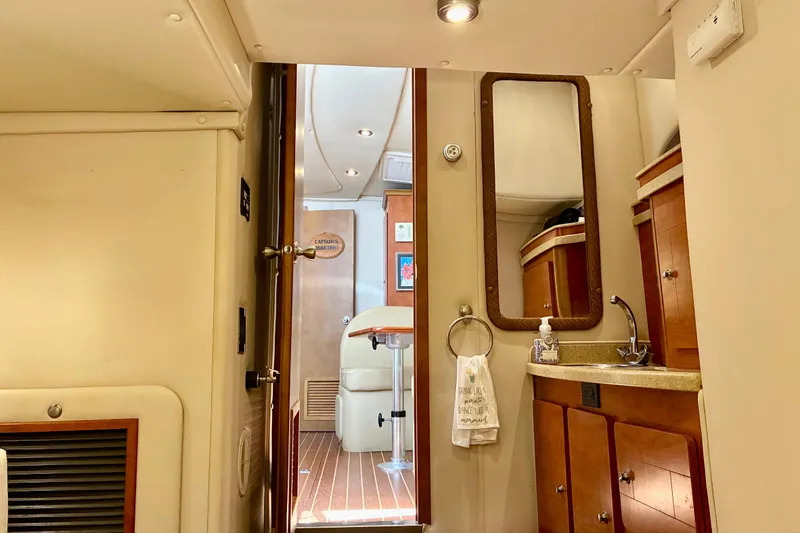 Slide: The Image of Interior of 2006 Rinker 390 Express Cruiser with wooden cabinetry and compact sink area. - 44