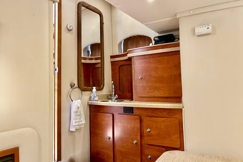 Slide: The Image of Interior of 2006 Rinker 390 Express Cruiser with wooden cabinetry and mirror. - 45