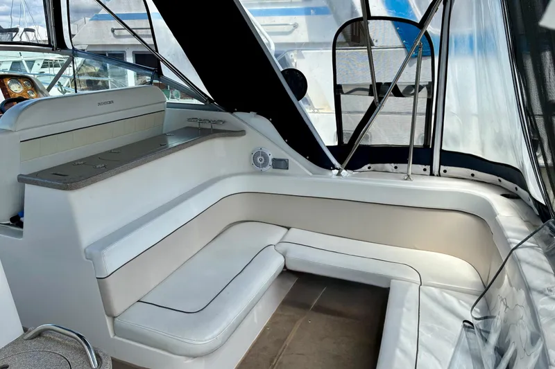 Slide: The Image of 2006 Rinker 390 Express Cruiser interior with white seating and dashboard. - 6