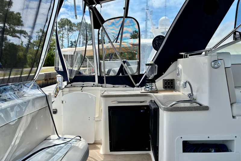 Slide: The Image of 2006 Rinker 390 Express Cruiser interior with kitchenette, sink, and seating area. - 8