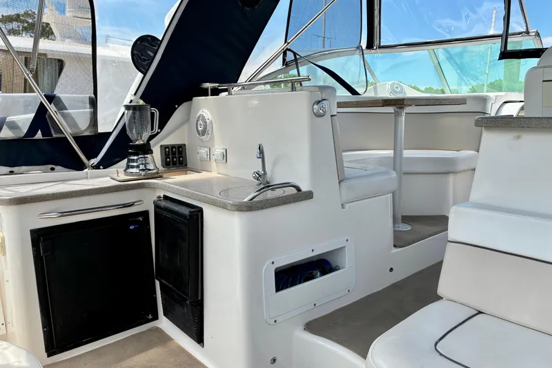 Slide: The Image of 2006 Rinker 390 Express Cruiser interior with kitchenette and seating area. - 9