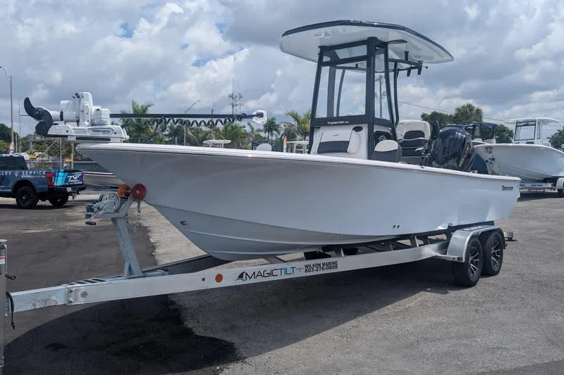 The Image of 2026 Tidewater 2300 Carolina Bay boat on trailer, parked outdoors under cloudy sky. - 0