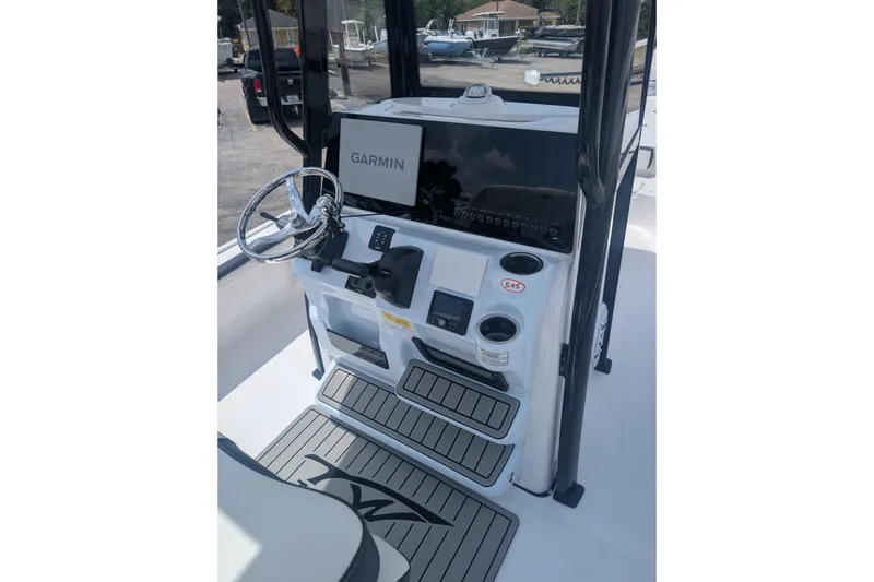 Slide: The Image of 2026 Tidewater 2300 Carolina Bay boat console with Garmin navigation system and steering wheel. - 3