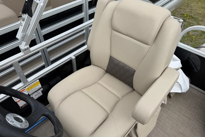 Slide: The Image of 2025 Sun Tracker Party Barge 16 DLX captain's chair with beige upholstery and armrests. - 46