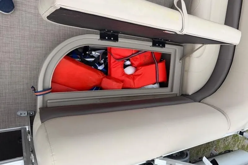 Slide: The Image of 2025 Sun Tracker Party Barge 16 DLX storage compartment with life jackets. - 50