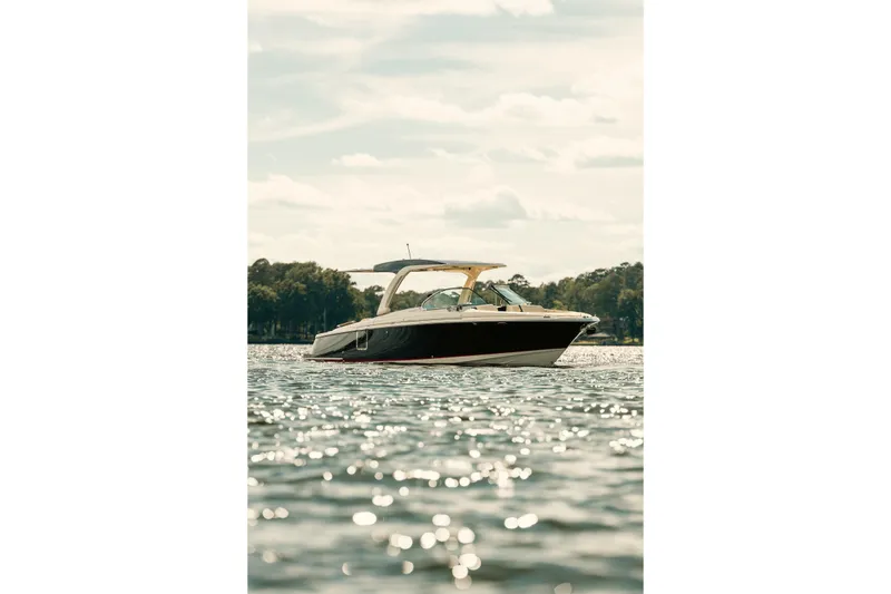 Slide: The Image of 2020 Chris-Craft Launch 31 GT boat interior with compact bathroom and wooden accents. - 10