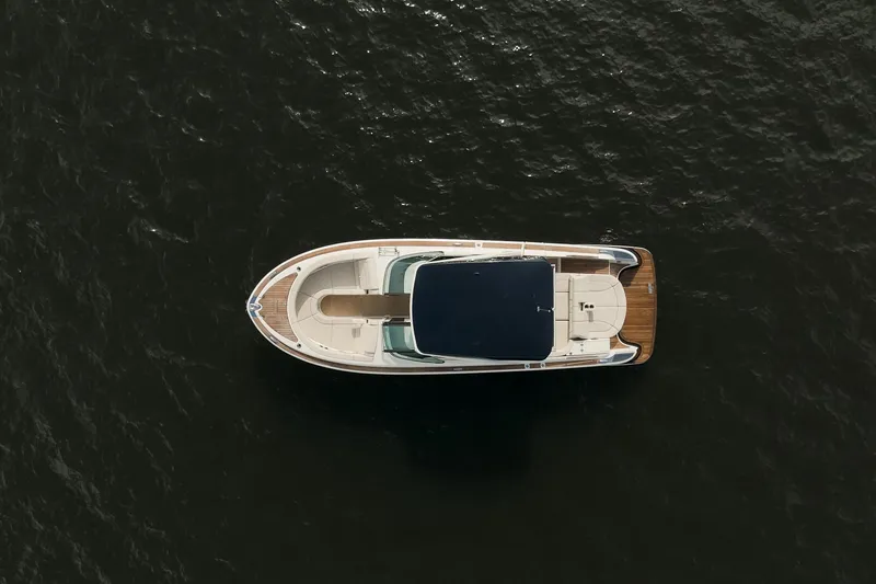 Slide: The Image of 2020 Chris-Craft Launch 31 GT boat dashboard with wooden accents and modern controls. - 11