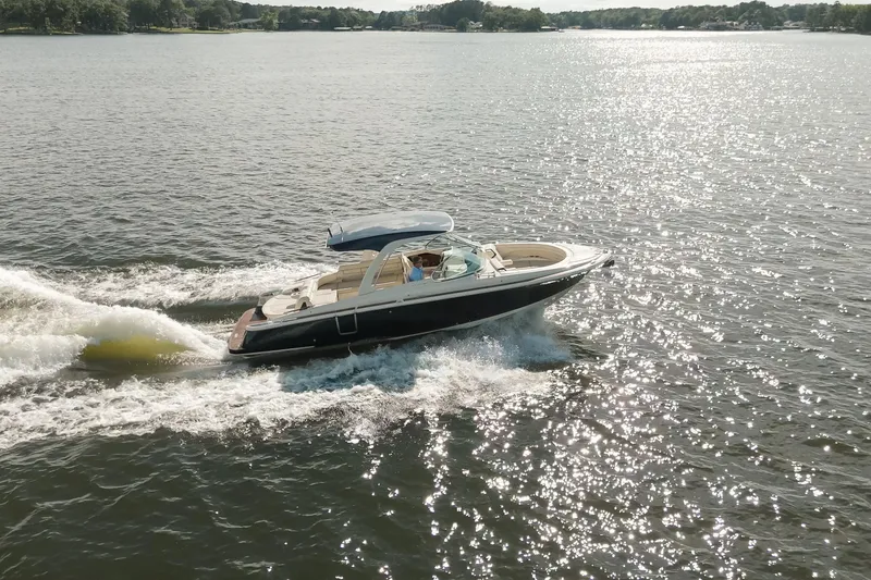 Slide: The Image of 2020 Chris-Craft Launch 31 GT dashboard with wooden steering wheel and modern controls. - 12