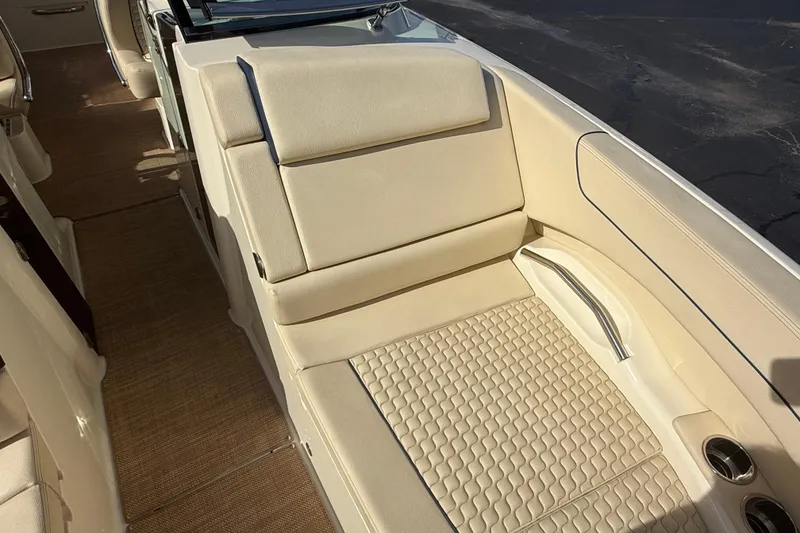 Slide: The Image of Luxurious seating on 2020 Chris-Craft Launch 31 GT boat, featuring beige upholstery and cup holders. - 19