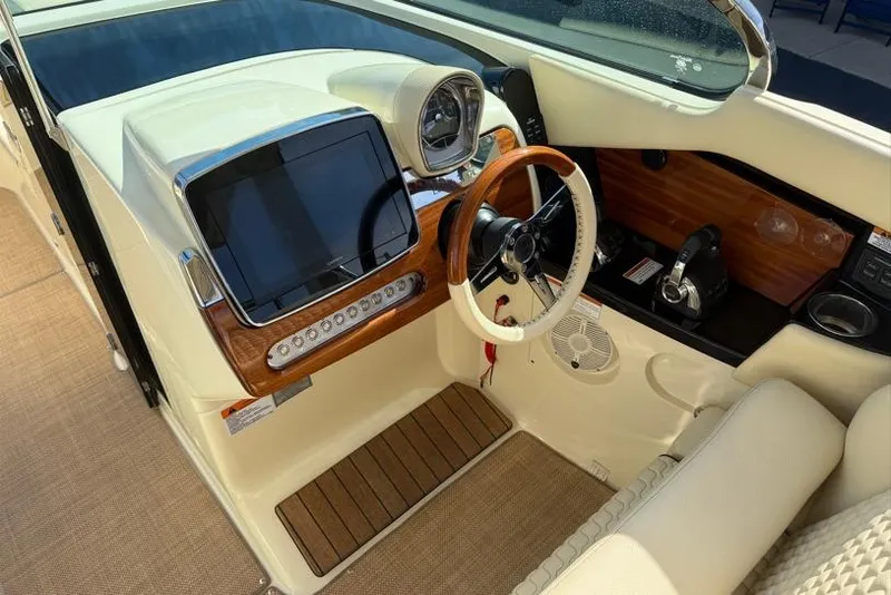 Slide: The Image of 2020 Chris-Craft Launch 31 GT boat dashboard with wooden accents and modern controls. - 25