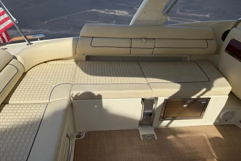 Slide: The Image of 2020 Chris-Craft Launch 31 GT interior with beige seating and American flag. - 29
