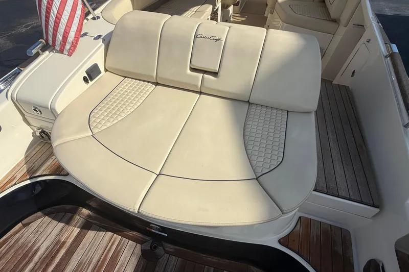 Slide: The Image of 2020 Chris-Craft Launch 31 GT boat with luxurious beige seating and American flag. - 31