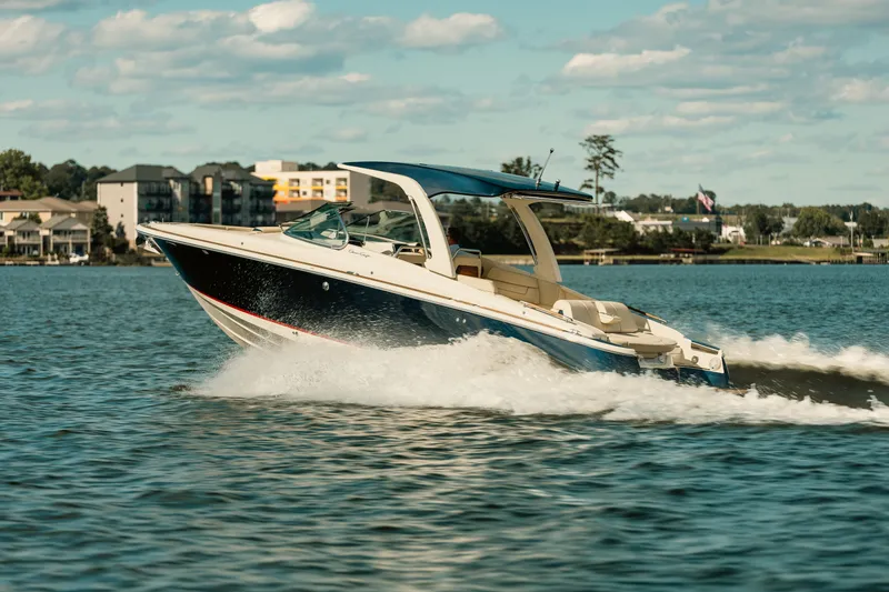 Slide: The Image of Luxurious seating on 2020 Chris-Craft Launch 31 GT boat, featuring beige upholstery and cup holders. - 5