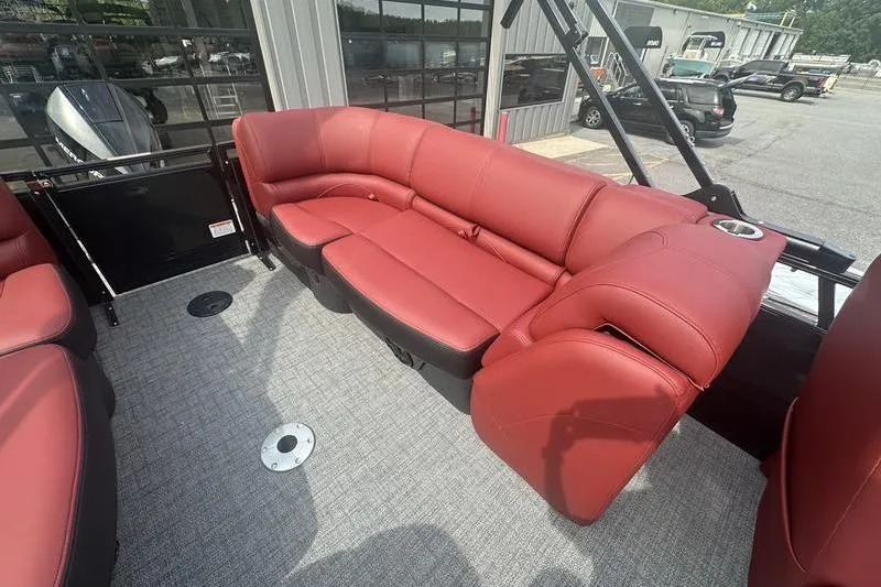 Slide: The Image of Red leather seating on 2026 Regency 230 DL boat, outdoor setting. - 1