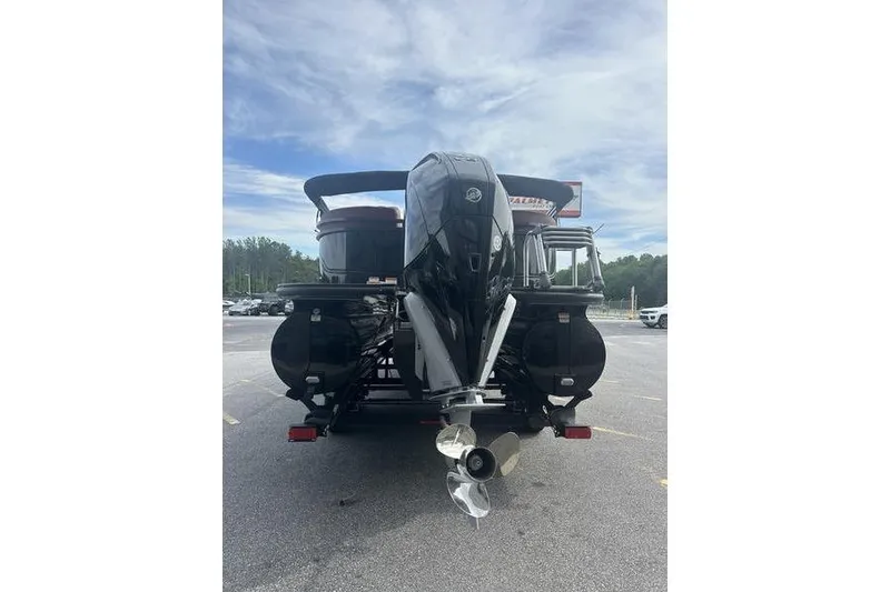 Slide: The Image of Rear view of 2026 Regency 230 DL boat with powerful outboard motor. - 12