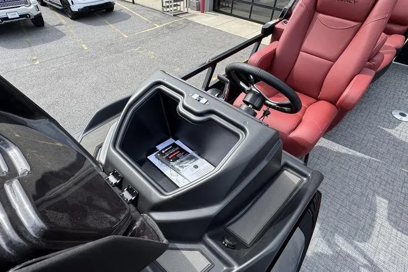 Slide: The Image of 2026 Regency 230 DL boat dashboard with red captain's chair and steering wheel. - 15