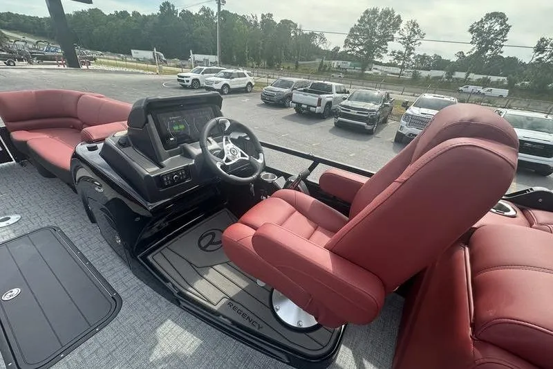 Slide: The Image of Luxurious 2026 Regency 230 DL boat interior with red seating and modern dashboard. - 16