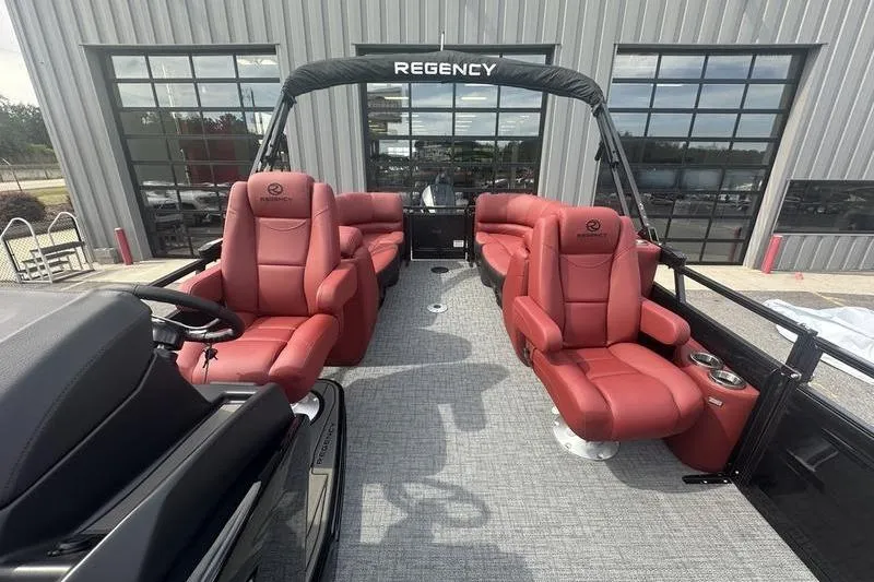 Slide: The Image of 2026 Regency 230 DL pontoon boat with luxurious red seating and modern design. - 17