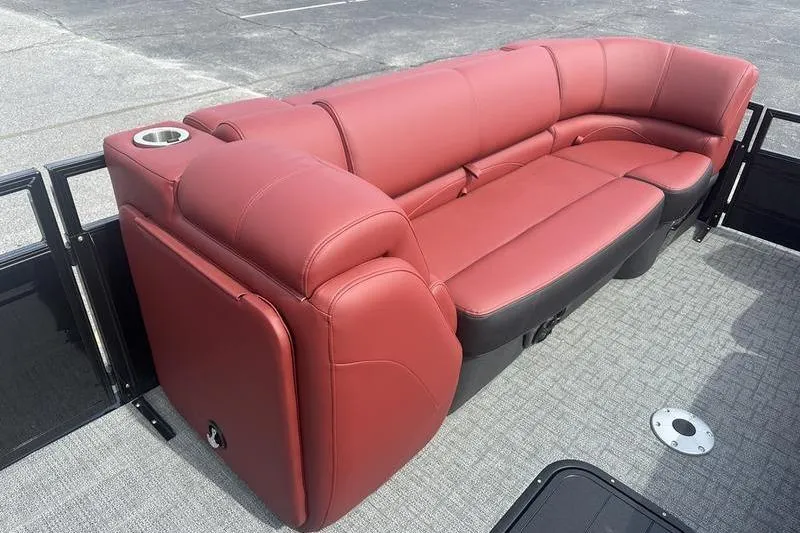 Slide: The Image of Luxurious red seating on 2026 Regency 230 DL pontoon boat, featuring cup holder. - 2