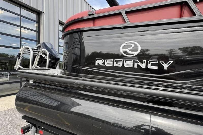 Slide: The Image of 2026 Regency 230 DL boat with sleek black exterior and red accents. - 7
