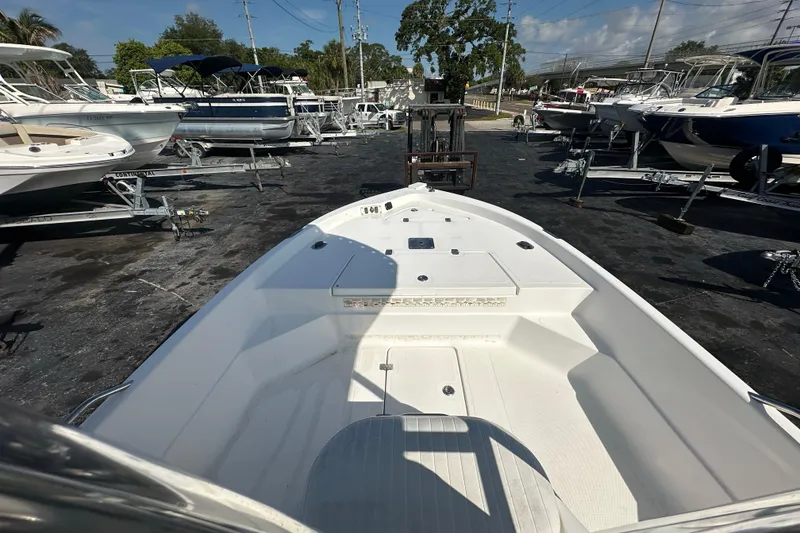 Slide: The Image of 2005 NauticStar 1900 NauticBay boat on trailer in marina, surrounded by other boats. - 10