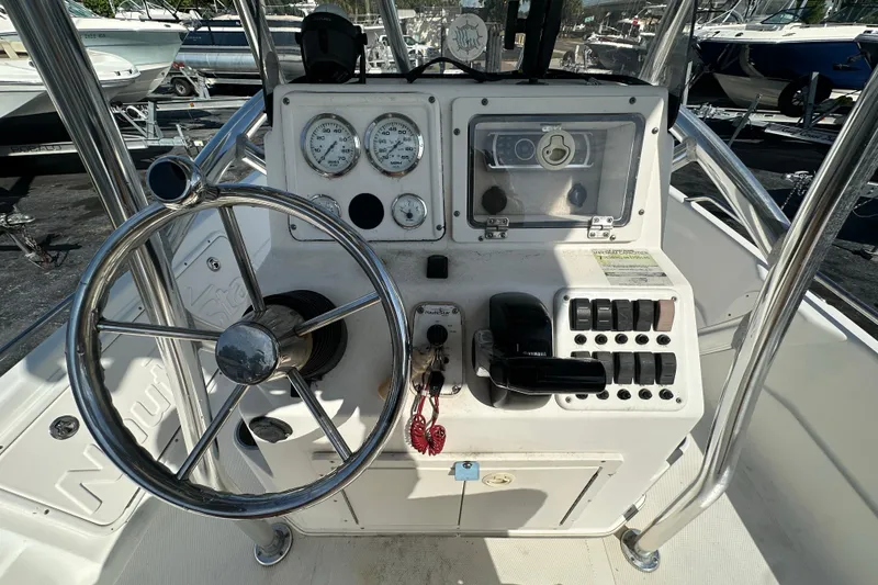 Slide: The Image of 2005 NauticStar 1900 NauticBay boat dashboard with steering wheel and control panel. - 15