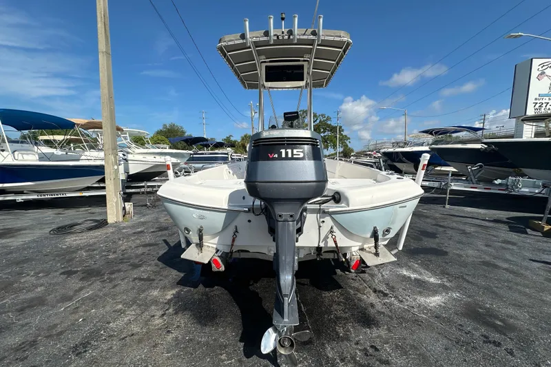 Slide: The Image of 2005 NauticStar 1900 NauticBay boat with V4 115 engine, parked in a marina. - 3