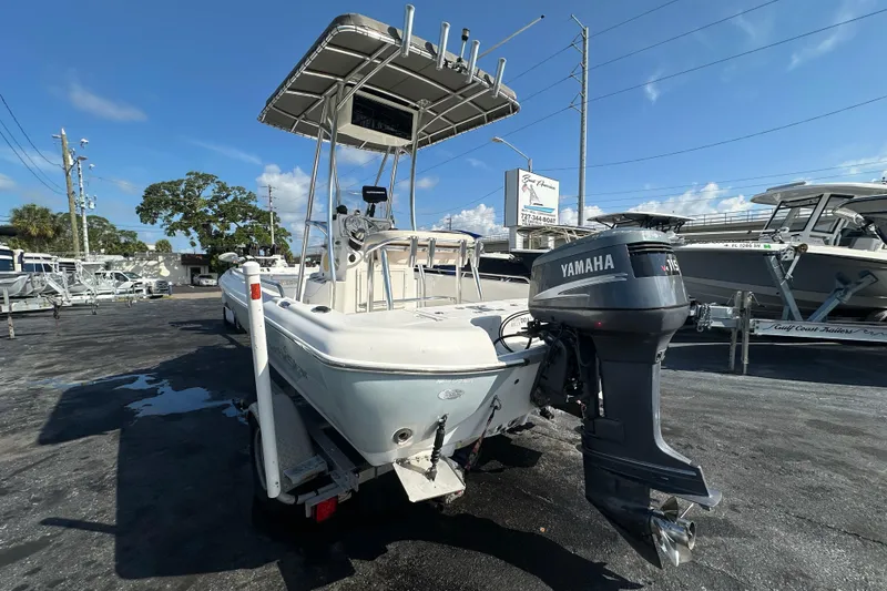Slide: The Image of 2005 NauticStar 1900 NauticBay boat with Yamaha outboard motor in a marina setting. - 4