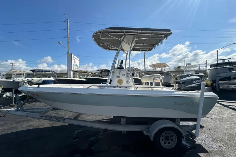 Slide: The Image of 2005 NauticStar 1900 NauticBay boat on trailer under clear blue sky. - 6