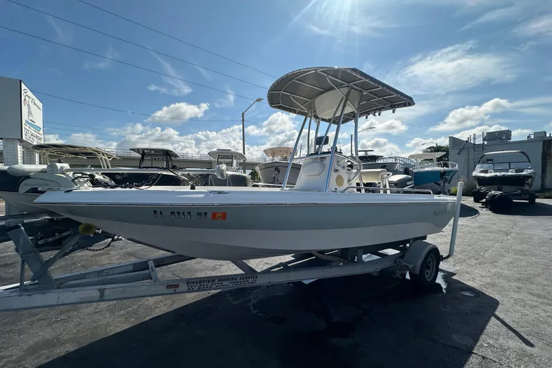 Slide: The Image of 2005 NauticStar 1900 NauticBay boat on trailer under sunny sky. - 7