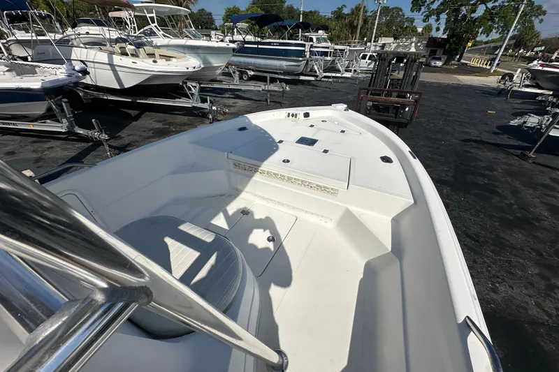 Slide: The Image of 2005 NauticStar 1900 NauticBay boat on display in a marina with other vessels. - 9