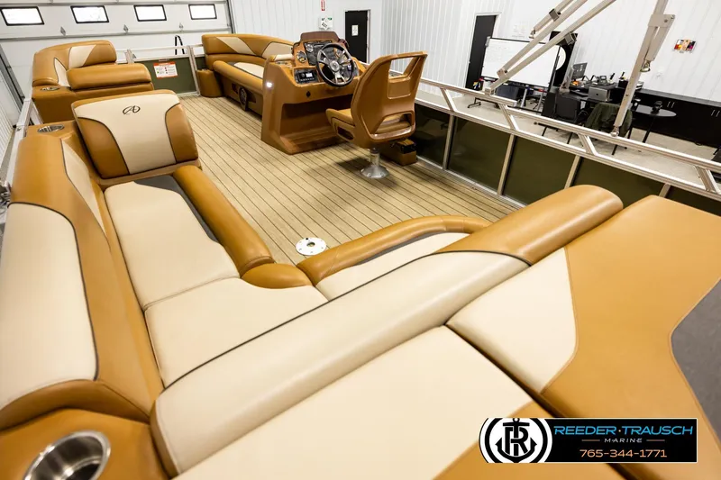 Slide: The Image of Luxurious 2023 Avalon VEN CR pontoon boat interior with tan seating and modern helm. - 11