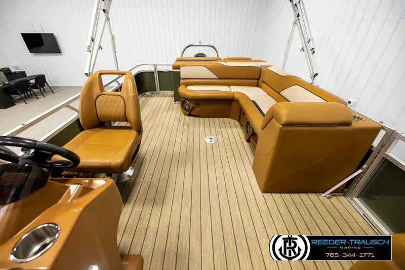 Slide: The Image of 2023 Avalon VEN CR boat interior with tan seating and wood-style flooring. - 14