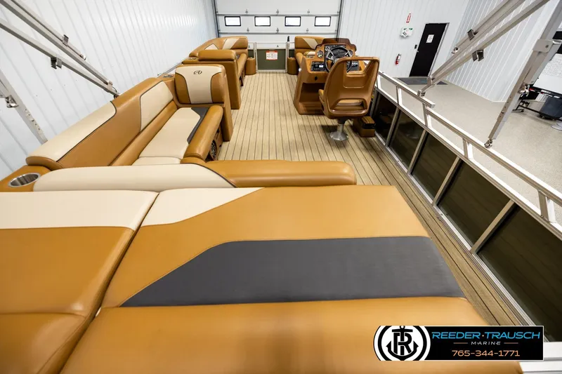 Slide: The Image of Luxurious interior of 2023 Avalon VEN CR pontoon boat with tan seating and modern helm. - 16