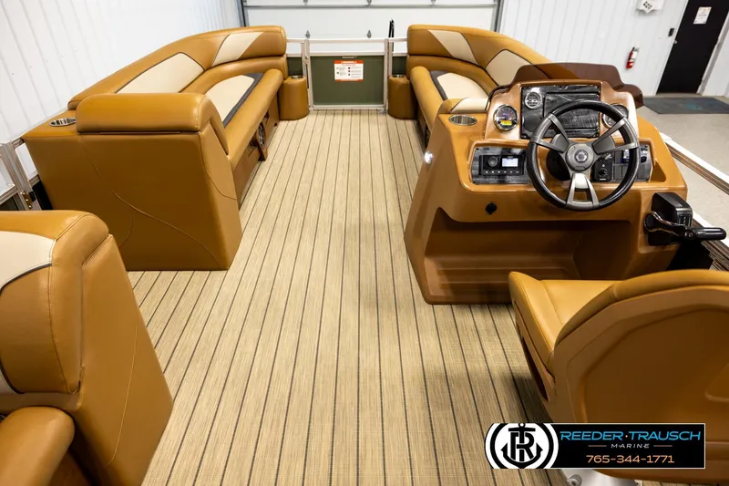 Slide: The Image of Interior of 2023 Avalon VEN CR boat with tan seating and modern steering console. - 17