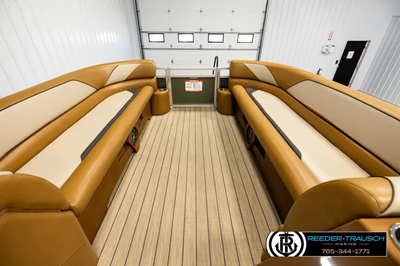 Slide: The Image of Luxurious interior of 2023 Avalon VEN CR boat with tan seating and striped flooring. - 18