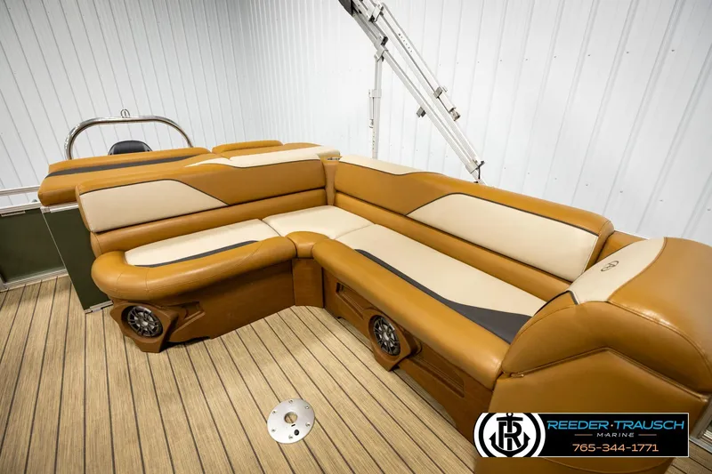 Slide: The Image of Luxurious 2023 Avalon VEN CR boat interior with tan leather seating and wood-style flooring. - 20