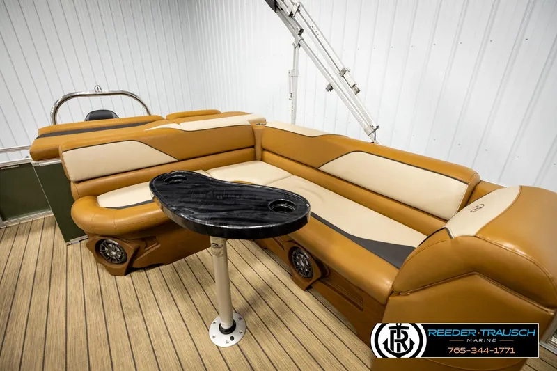 Slide: The Image of Luxurious 2023 Avalon VEN CR boat interior with tan seating and sleek black table. - 22