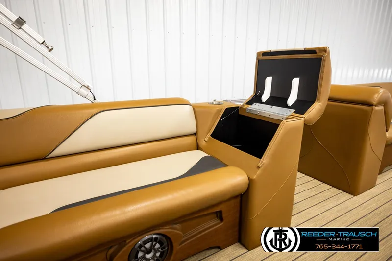 Slide: The Image of 2023 Avalon VEN CR boat interior with tan leather seating and storage compartment. - 27