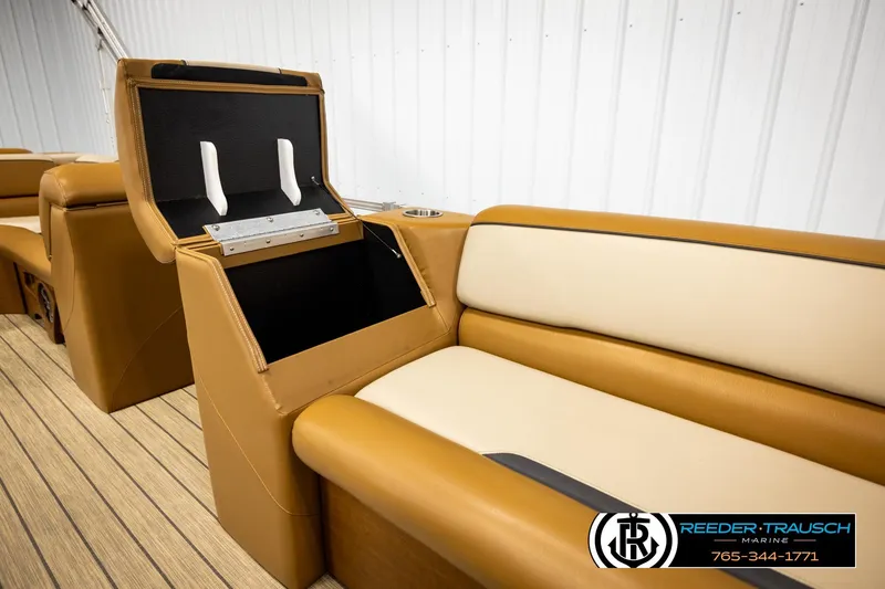 Slide: The Image of 2023 Avalon VEN CR boat interior with tan seating and storage compartment open. - 29