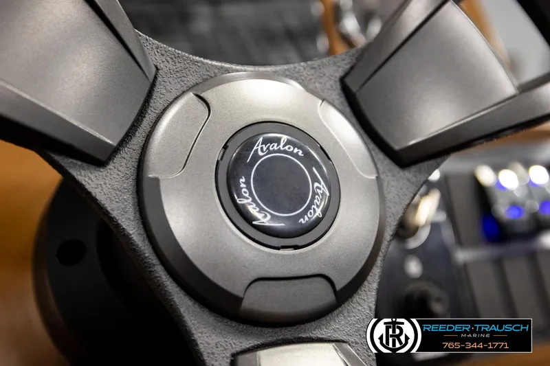 Slide: The Image of Close-up of 2023 Avalon VEN CR steering wheel with logo detail. - 32