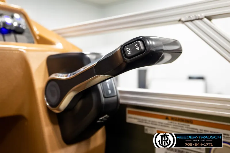Slide: The Image of Close-up of 2023 Avalon VEN CR boat throttle control lever with "UP" and "DN" buttons. - 39