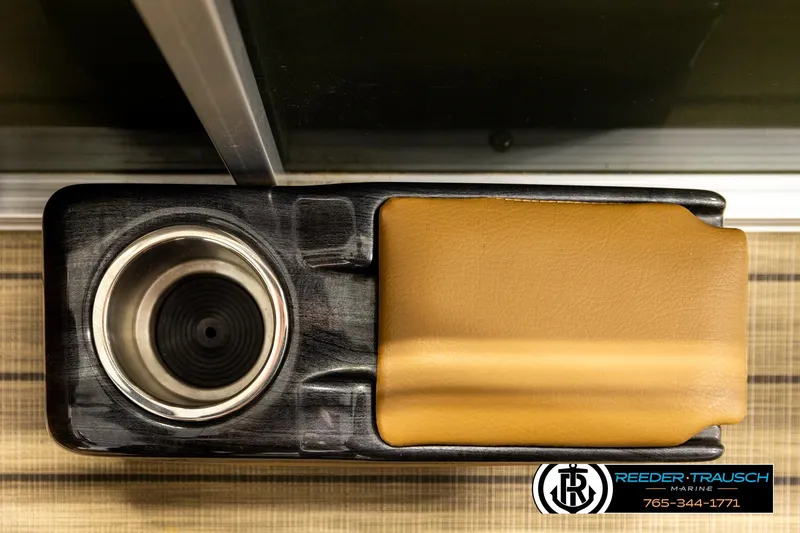 Slide: The Image of 2023 Avalon VEN CR boat cup holder and armrest detail, Reeder-Trausch Marine branding. - 40