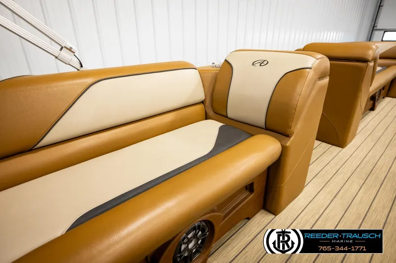 Slide: The Image of 2023 Avalon VEN CR boat interior with tan and cream seating, featuring Reeder-Trausch Marine branding. - 42