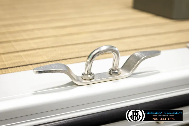 Slide: The Image of Stainless steel cleat on 2023 Avalon VEN CR boat deck, Reeder Trausch Marine branding visible. - 58