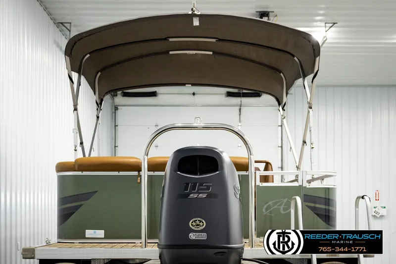 Slide: The Image of 2023 Avalon VEN CR pontoon boat with canopy and outboard motor in a showroom. - 7
