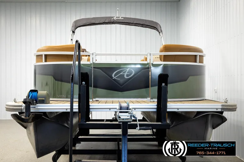 Slide: The Image of 2023 Avalon VEN CR pontoon boat in showroom, featuring sleek design and modern amenities. - 8